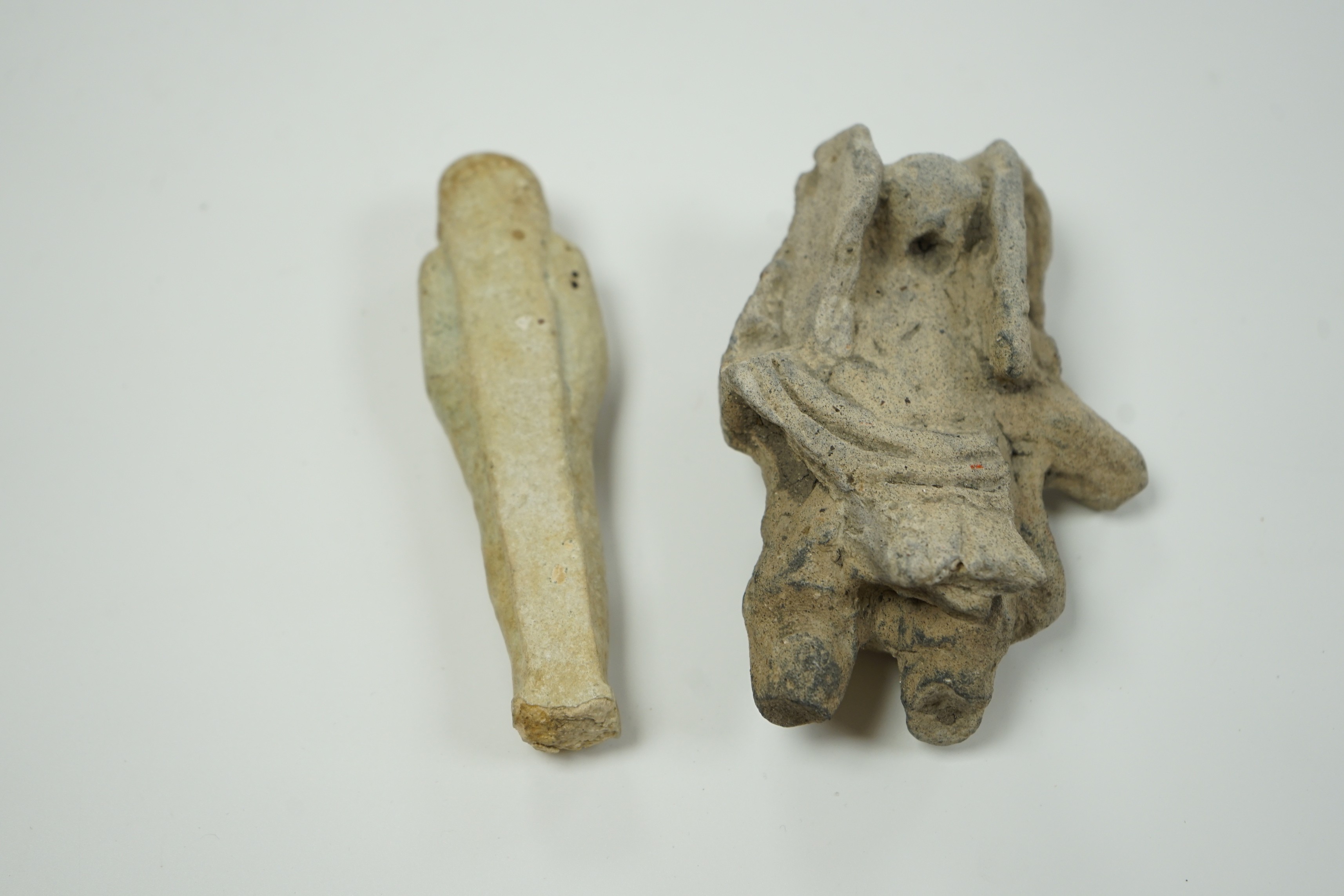 An Egyptian cream faience ushabti and a pre-Columbian pottery figure, 10cm high